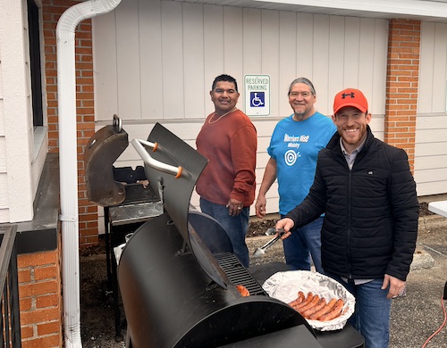 Three volunteers Grilling at the Church.